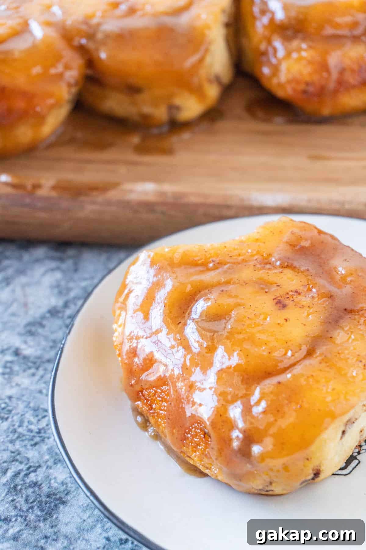 Sticky Caramel Cinnamon Rolls with Gooey Glaze 6 Sticky bun on plate