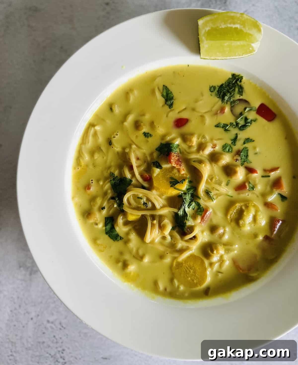 Creamy vegan ramen noodle soup in a bowl on the table. 