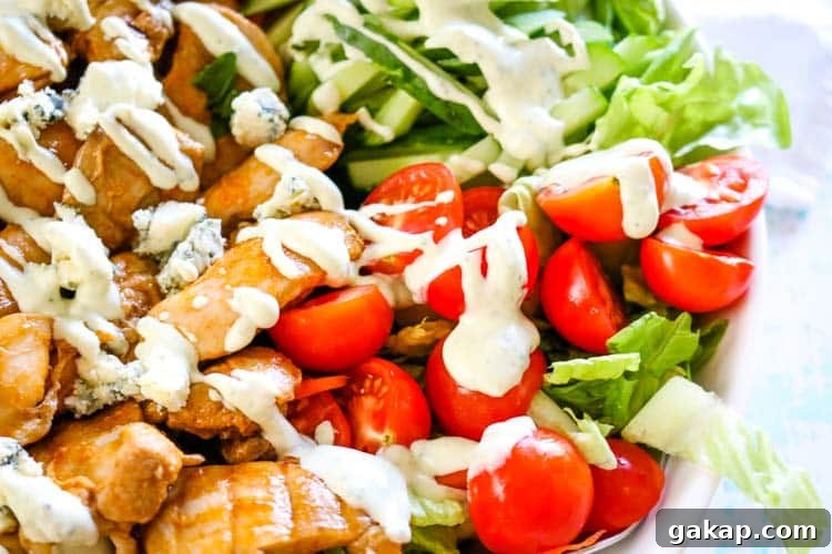 Creamy blue cheese dressing drizzled over buffalo chicken dressing