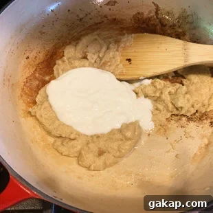 Black Pepper Paneer (Paneer Kali Mirch) — Spicy Indian Cottage Cheese 13 pan with white color paste and yogurt being added to it