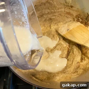 Black Pepper Paneer (Paneer Kali Mirch) — Spicy Indian Cottage Cheese 15 water being added to a pan with a paste in it