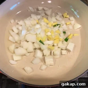 Black Pepper Paneer (Paneer Kali Mirch) — Spicy Indian Cottage Cheese 8 a pan with diced onion, ginger, chilies