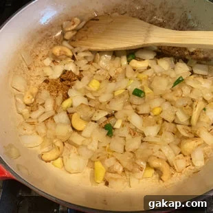 Black Pepper Paneer (Paneer Kali Mirch) — Spicy Indian Cottage Cheese 9 a pan with sauteed onion, ginger, cashews and chili