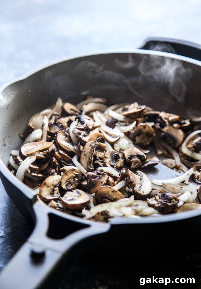 mushrooms cooking in a skillet