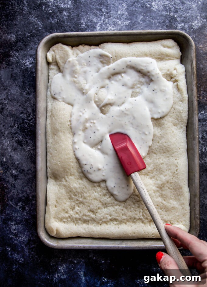 white garlic sauce spreading on pizza dough