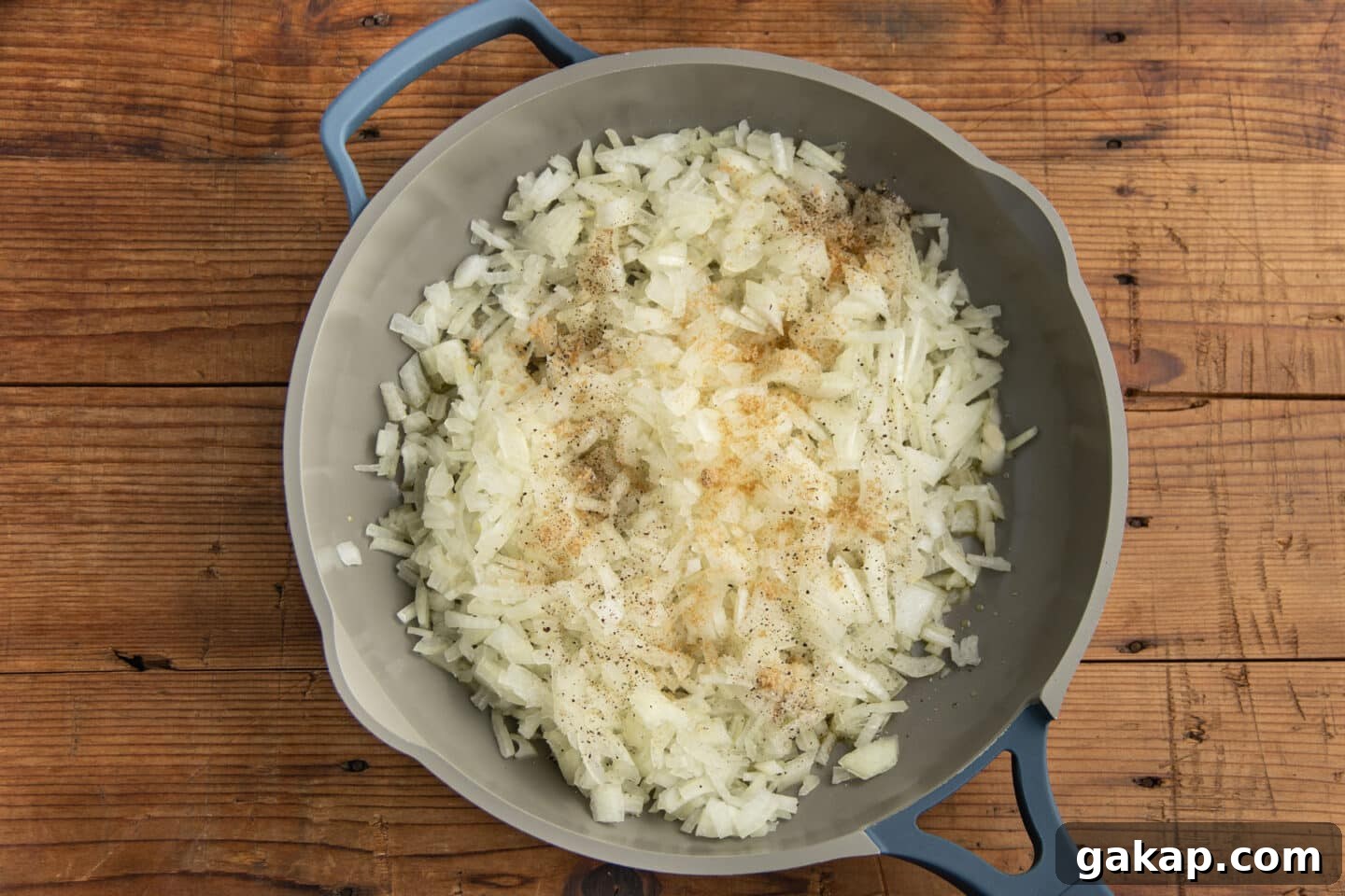 This is a picture of a skillet with the onions and seasoning.