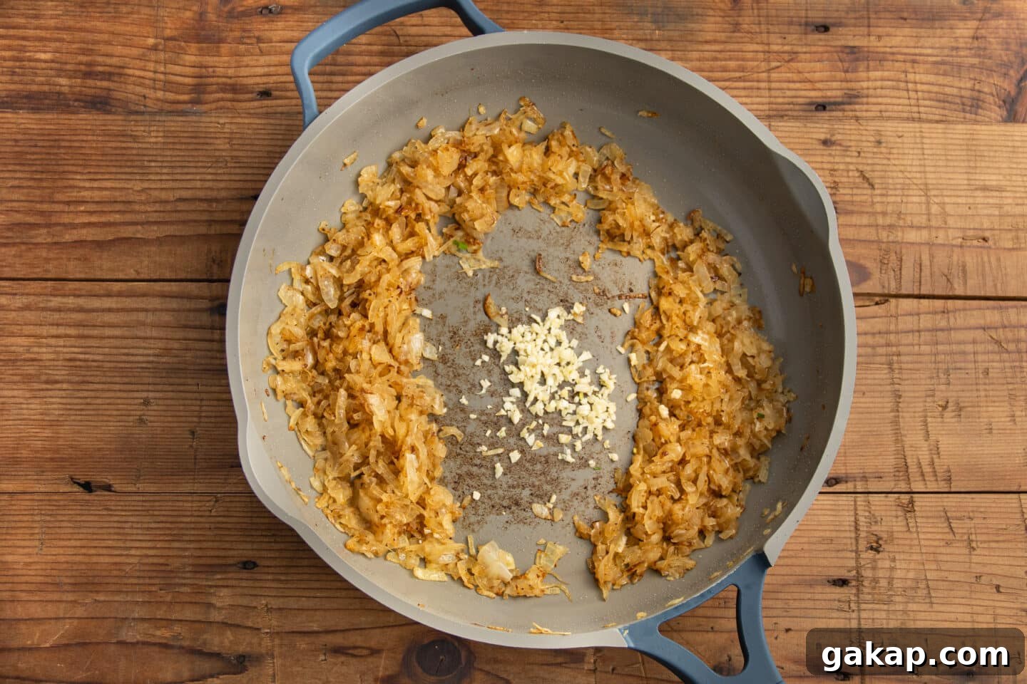 This is a picture of the skillet with the onions cooking and added garlic.