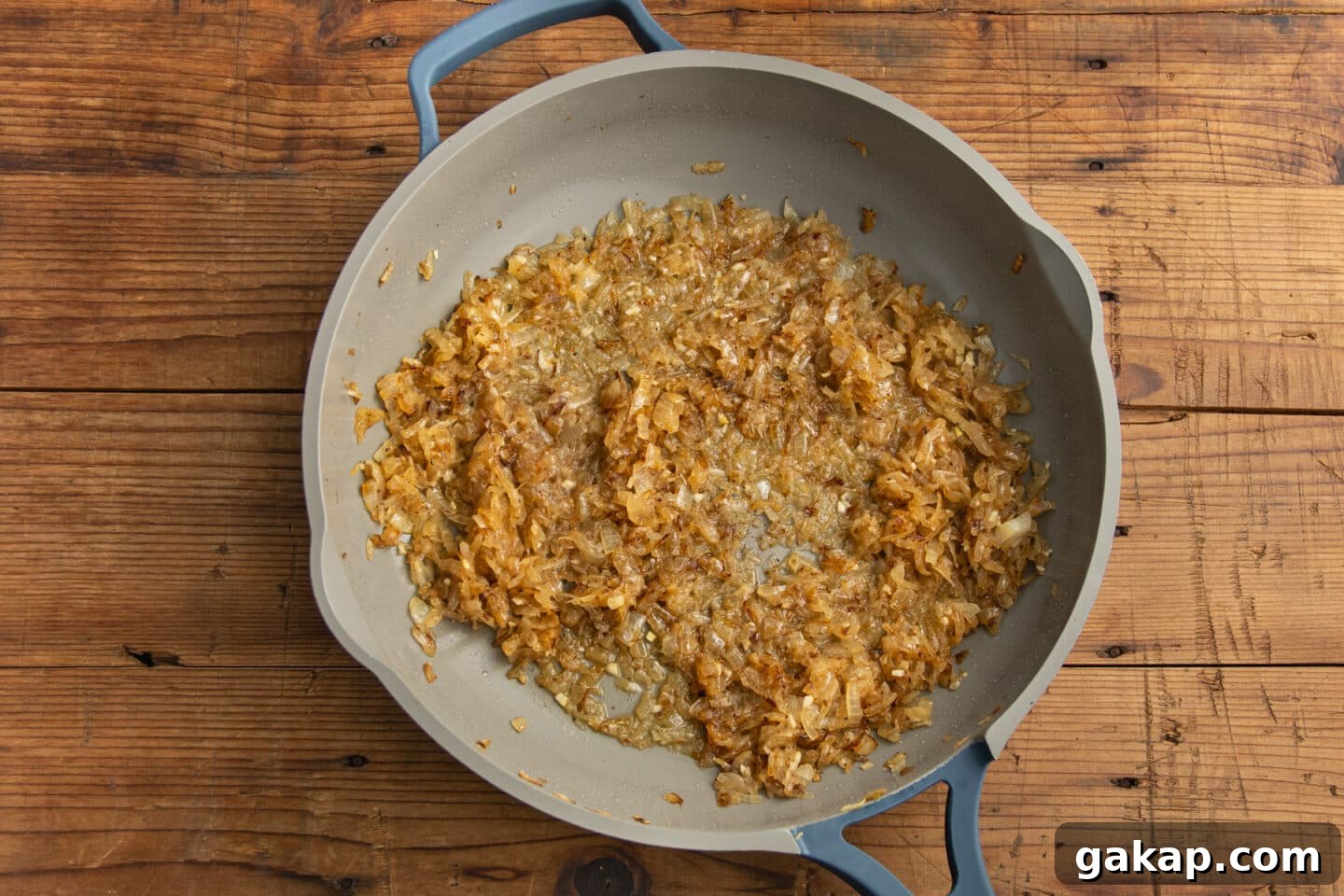 This is a picture of the skillet with the onions cooking with water added to deglaze the pan.