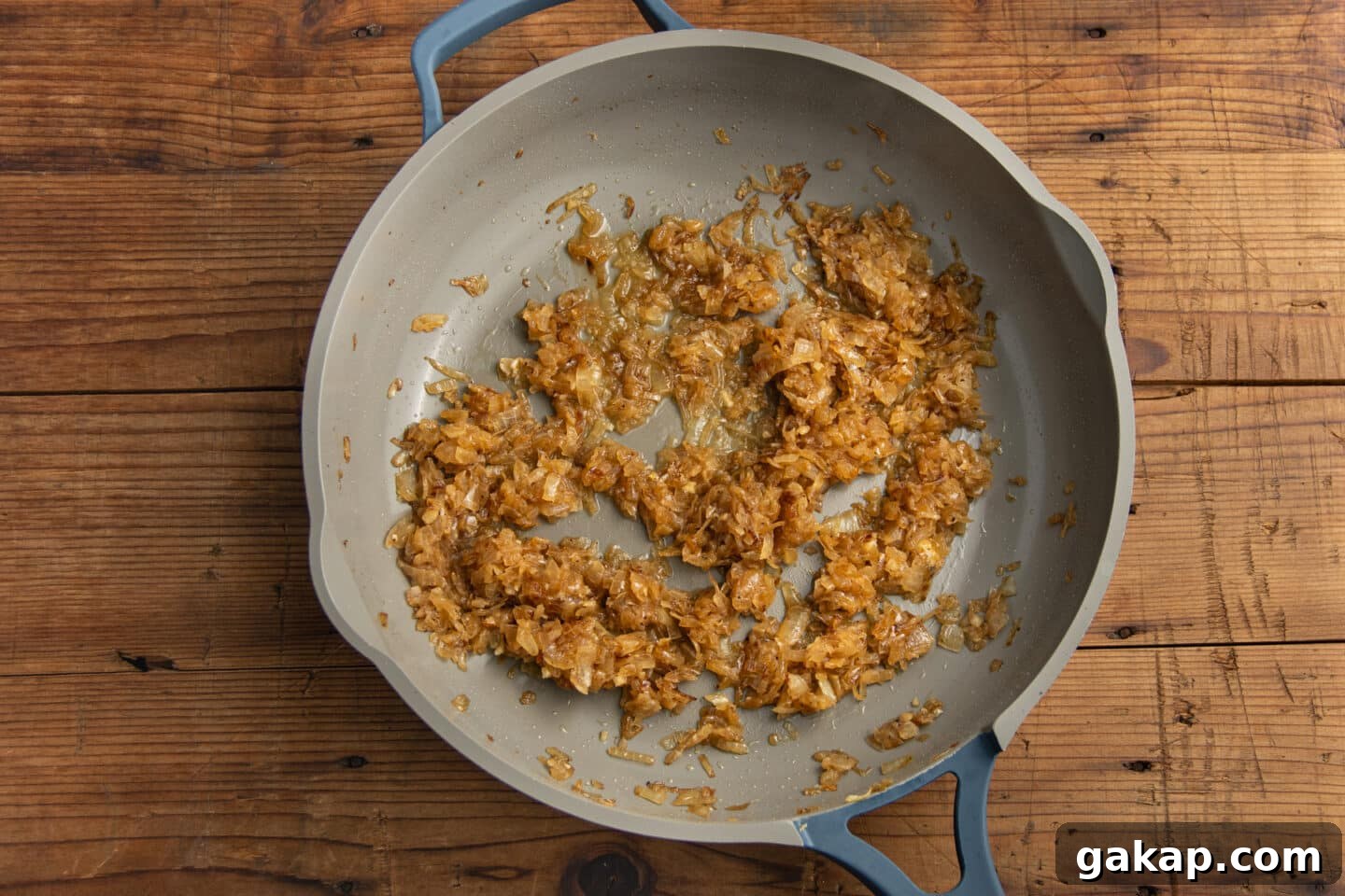 This is a picture of the skillet with the onions cooking.