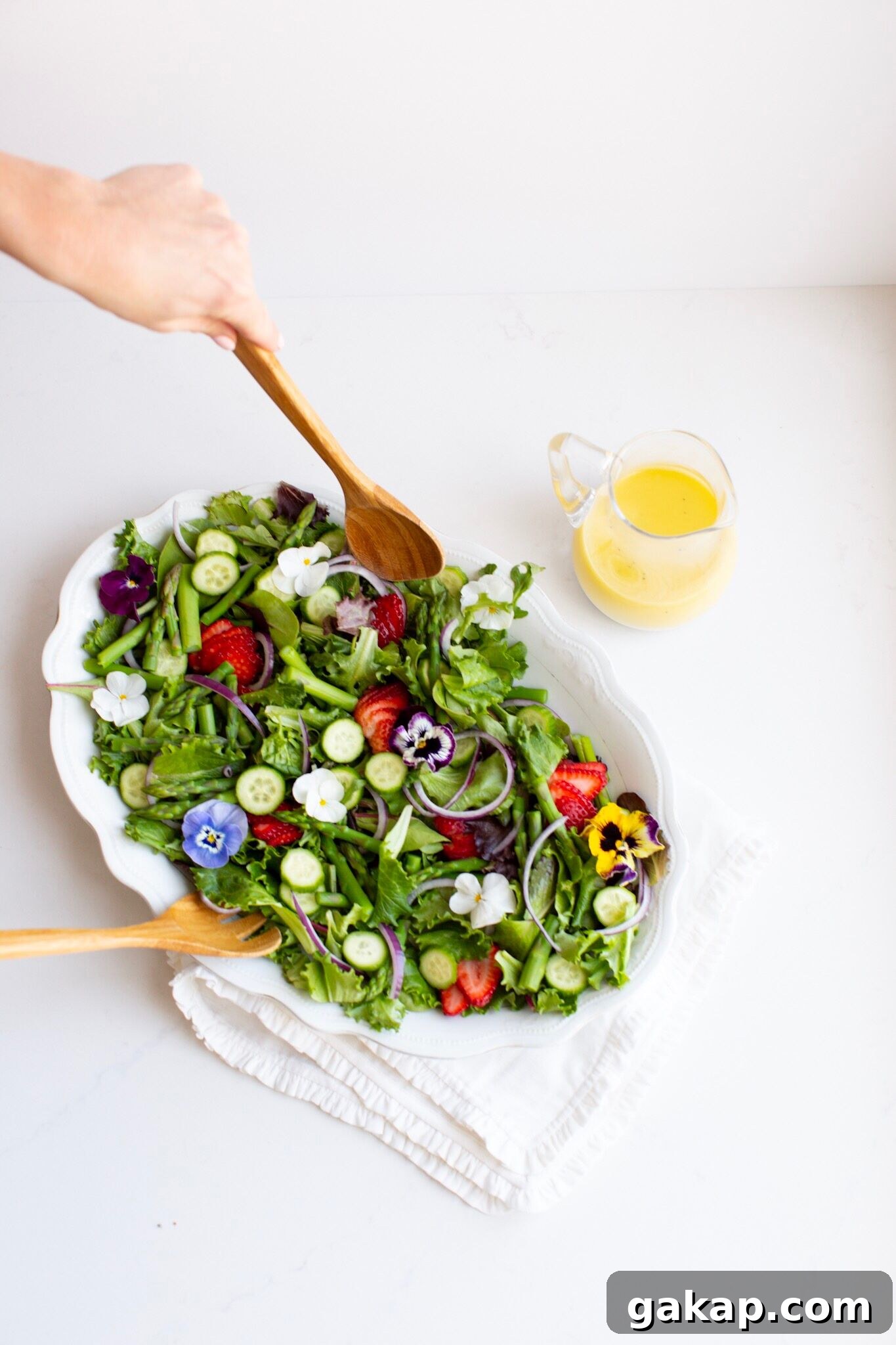 Spring Salad with edible flowers and creamy lemon vinaigrette.
