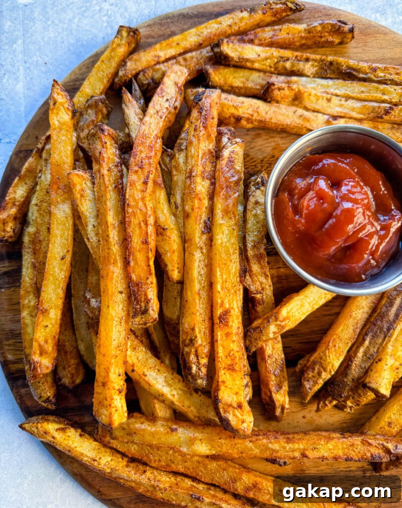 Cajun fries on a platter with ketchup