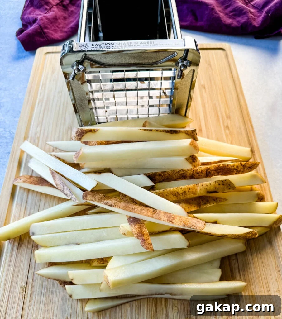 sliced russet potatoes cut into fries with a fry cutter