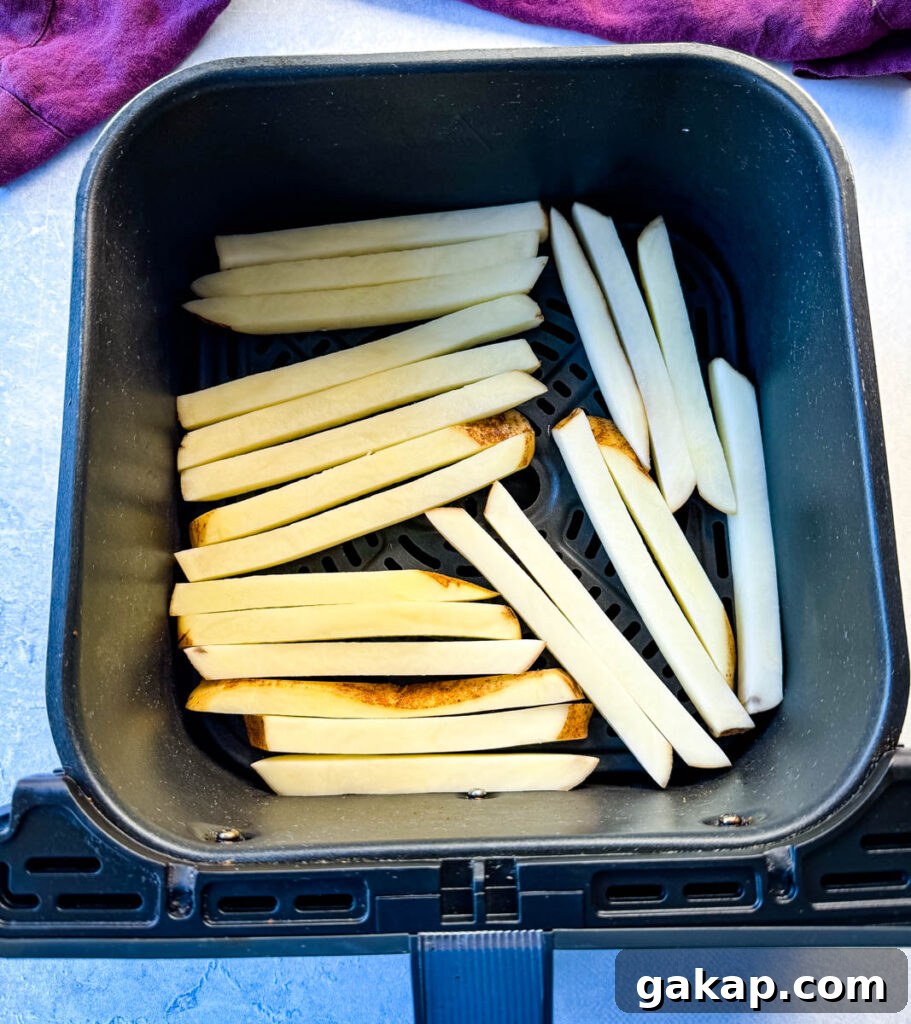 sliced potatoes in an air fryer