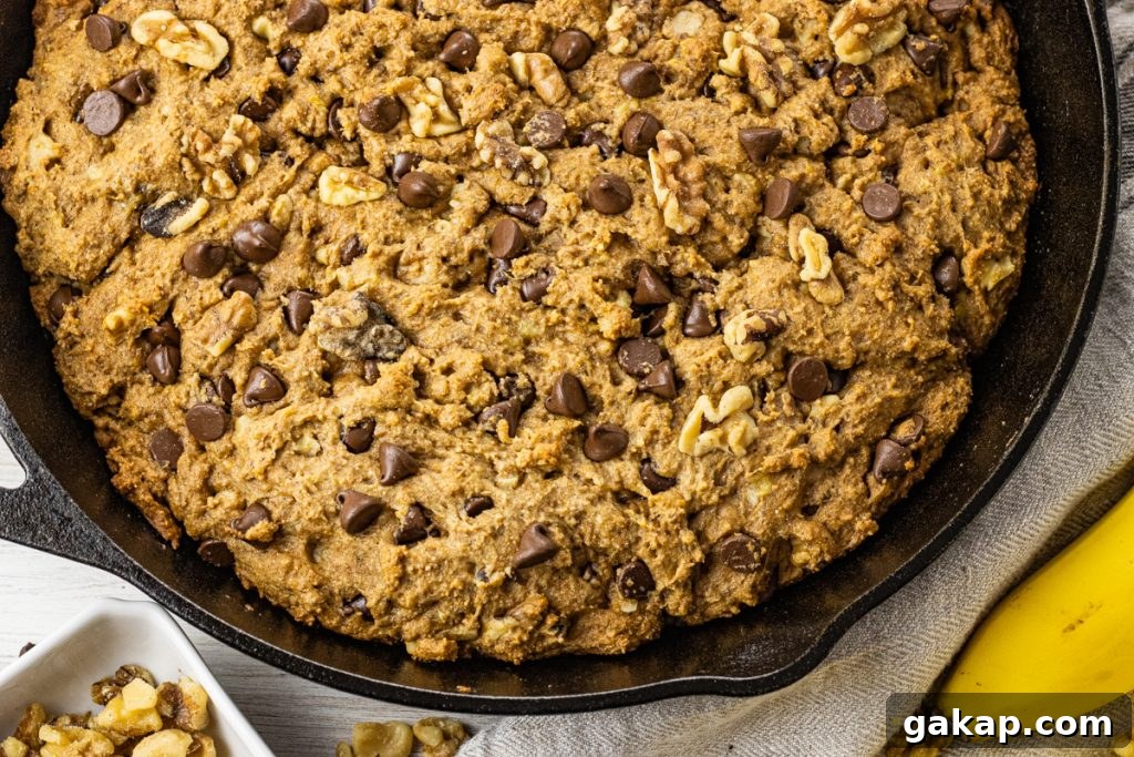 Moist Whole Wheat Banana Bread with Walnuts and Cinnamon 6 pan of cooked chocolate chip banana bread in black cast iron pan