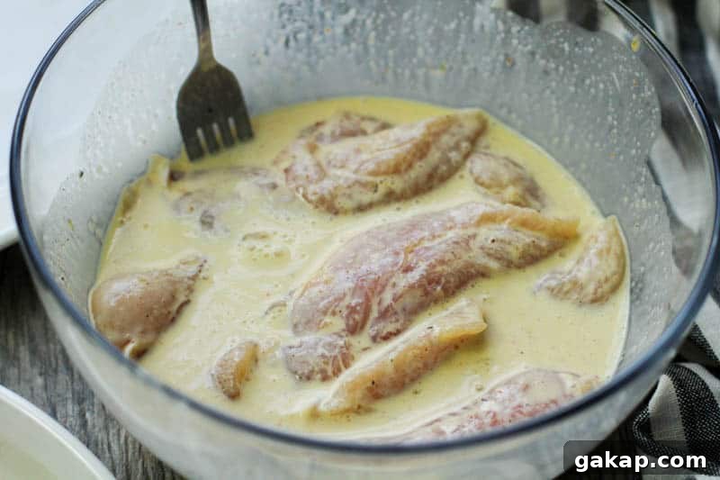 chicken tenders marinating in buttermilk