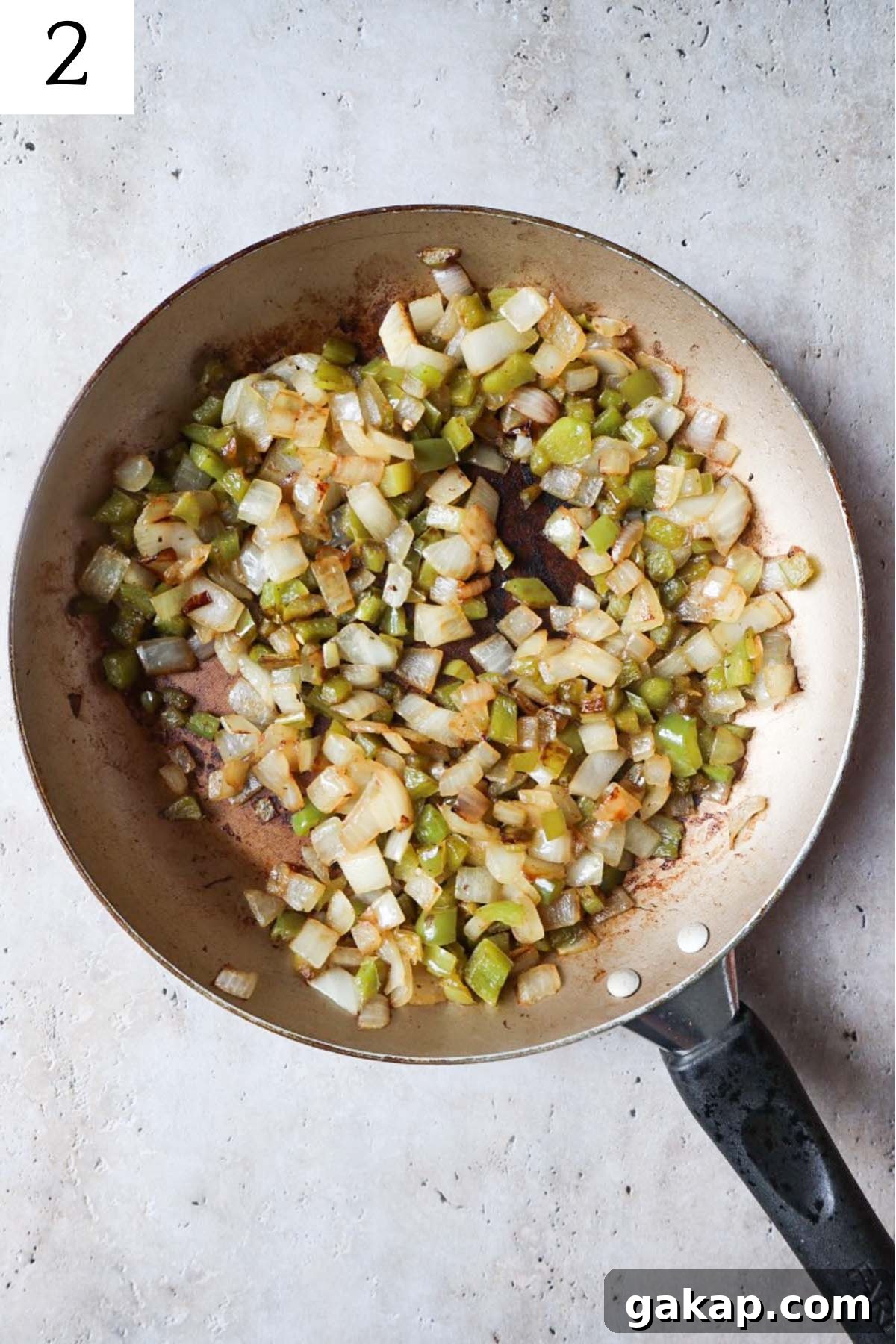 Chipotle Peach Baked Beans Recipe for Sweet-Spicy BBQ Sides 5 skillet with onion and green bell peppers cooked in bacon fat.