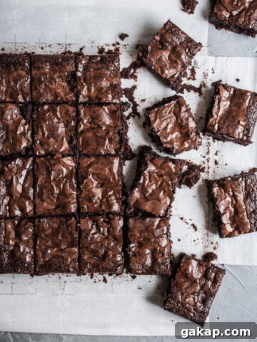 Squares of brownies on parchment.