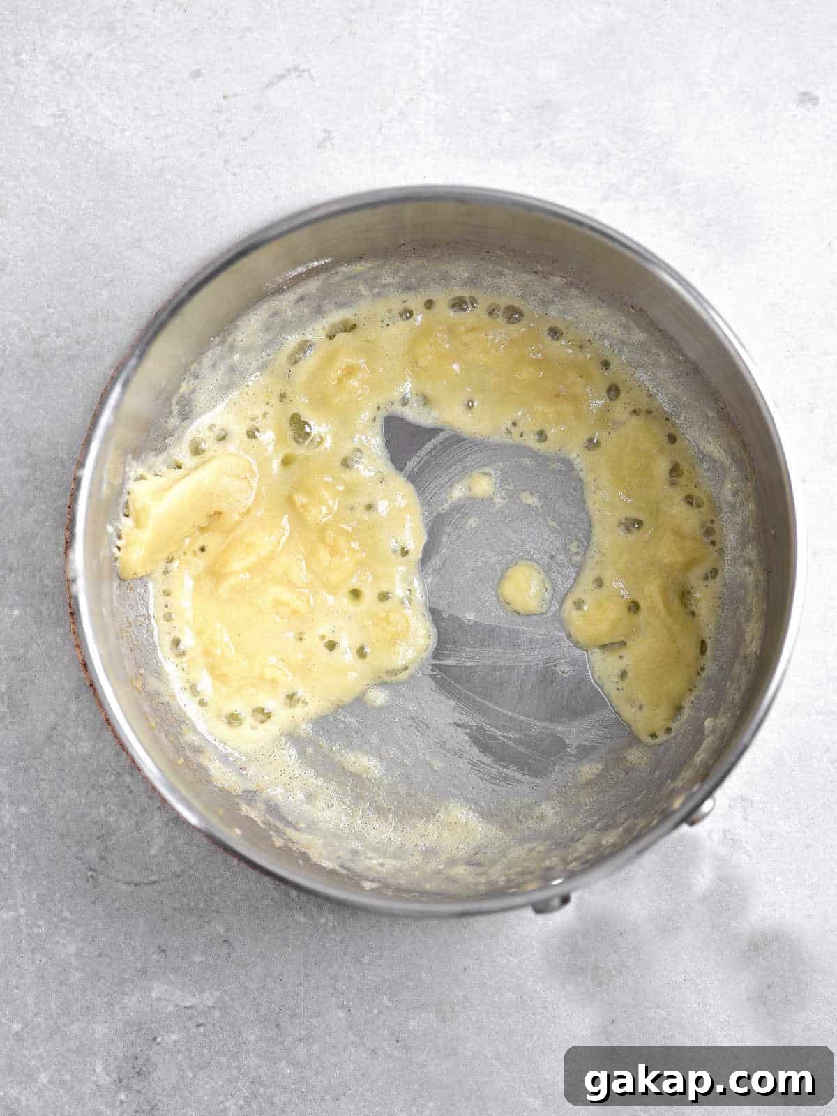 Perfect Slow-Roasted Leg of Lamb Recipe for Tender Meat 8 Mixture of butter and flour in a metal pan on a light grey surface.
