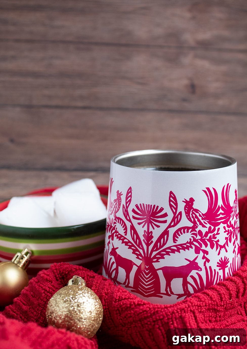 Keto Peppermint Coffee Flavor Shots — Low-Carb Fat Bombs 2 keto peppermint flavor shots in a bowl in the background and a cup of hot coffee in the foreground with a red towel