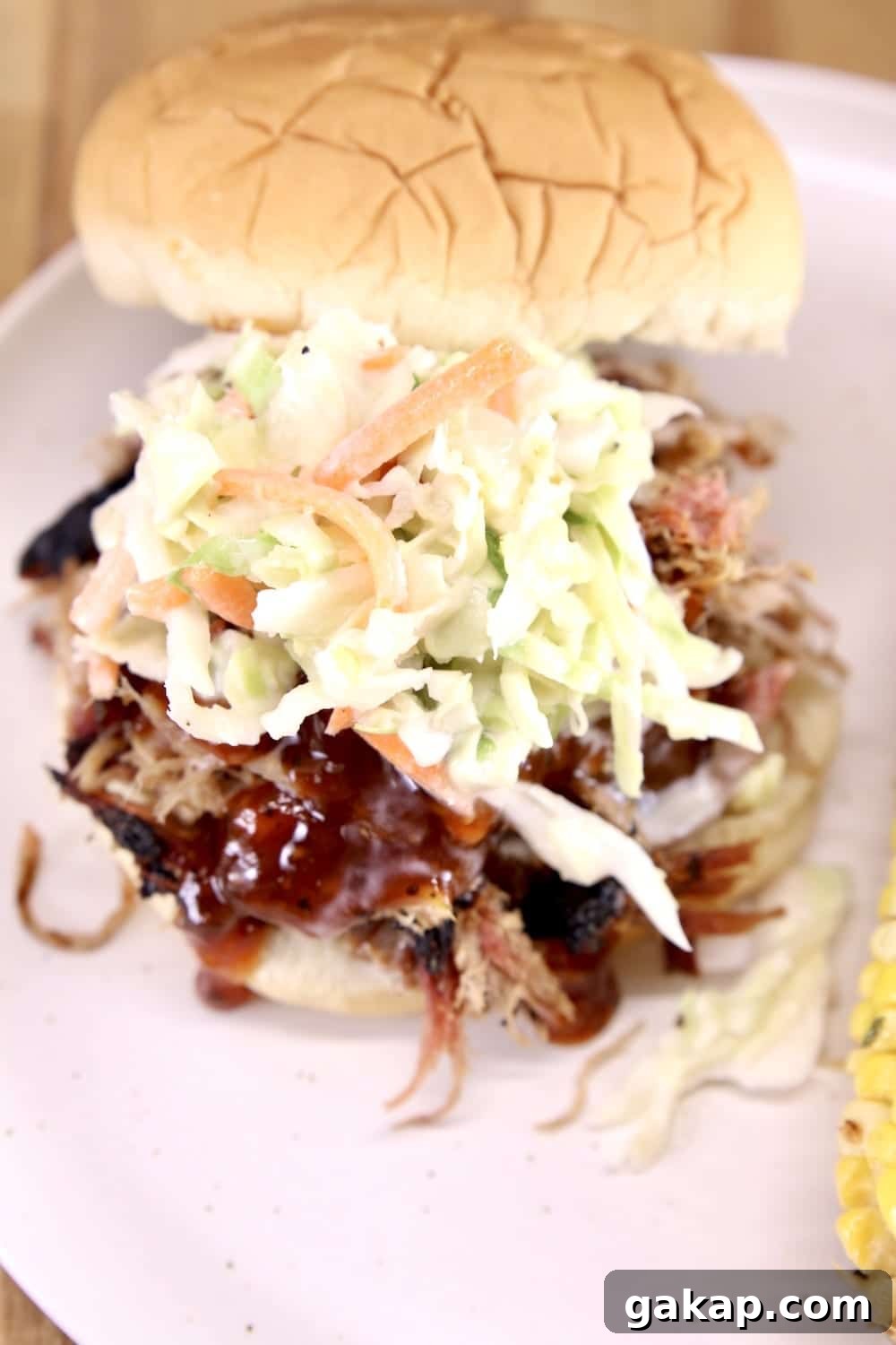 Smoky Pulled Pork Sandwiches with bbq sauce and slaw Pulled pork sandwich with bbq sauce and slaw