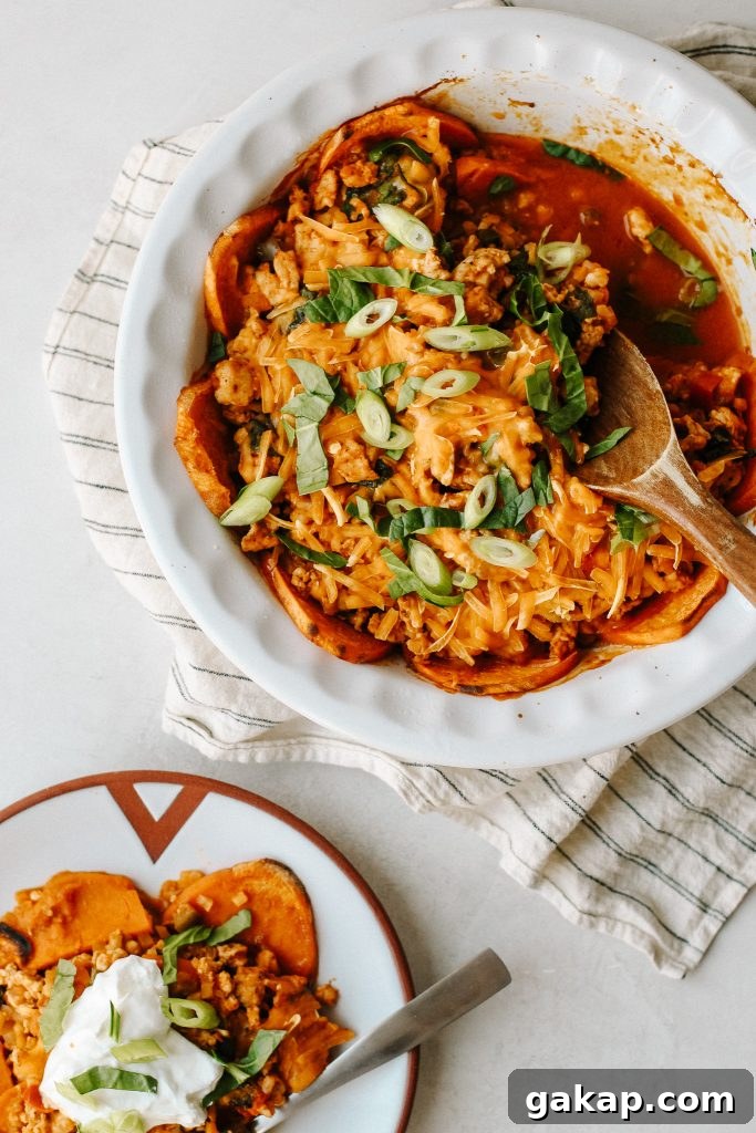 enchilada sweet potato casserole in a baking dish with wood spoon and on a plate with sour cream 