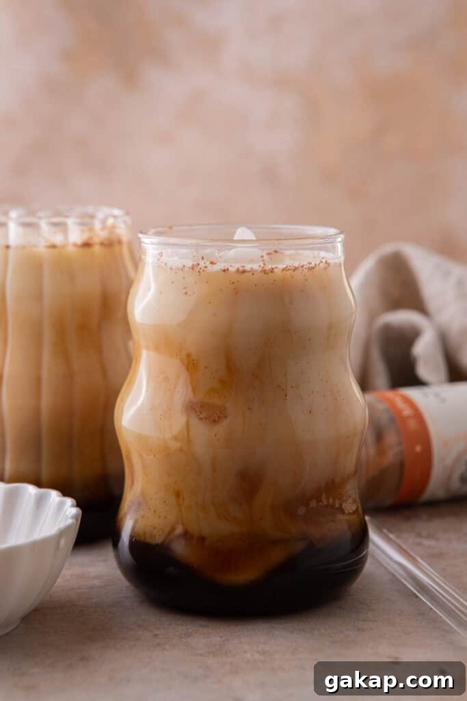 Honey Oatmilk Latte Recipe: Hot & Iced Starbucks-Style Guide 6 Creamy iced honey oat milk latte with espresso and oat milk swirling together.