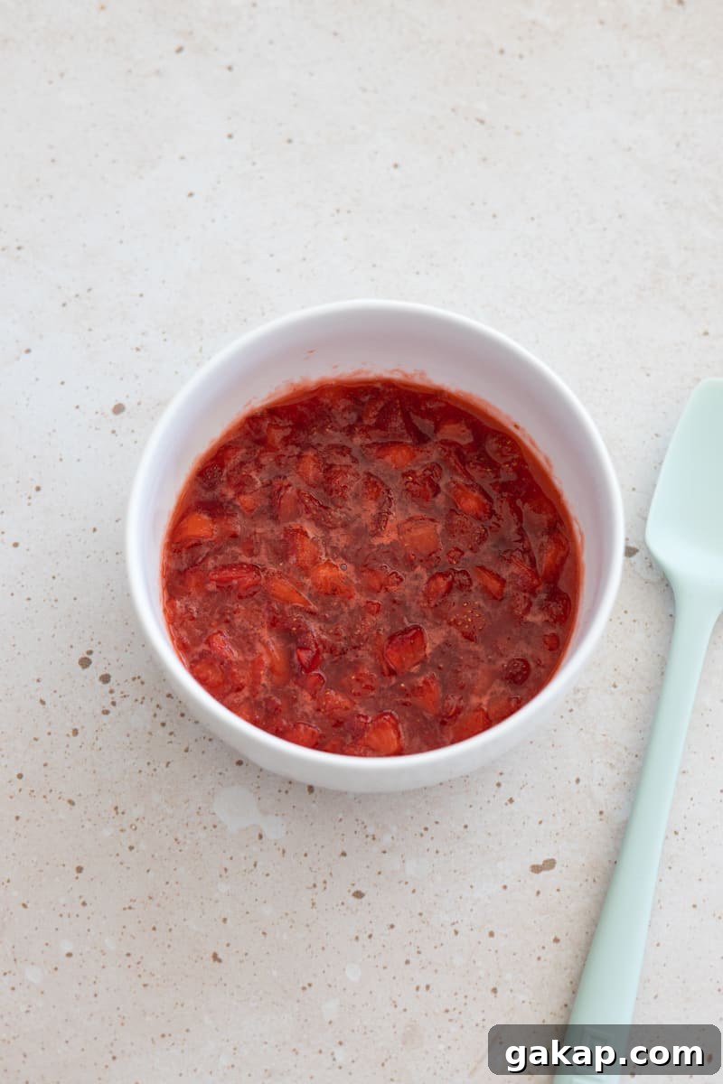 Strawberry compote in a white bowl.