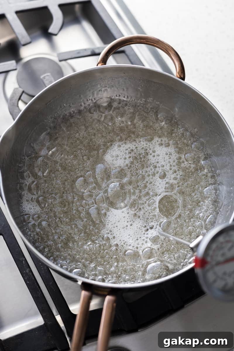 Sugar and corn syrup boiling in a saucepan.