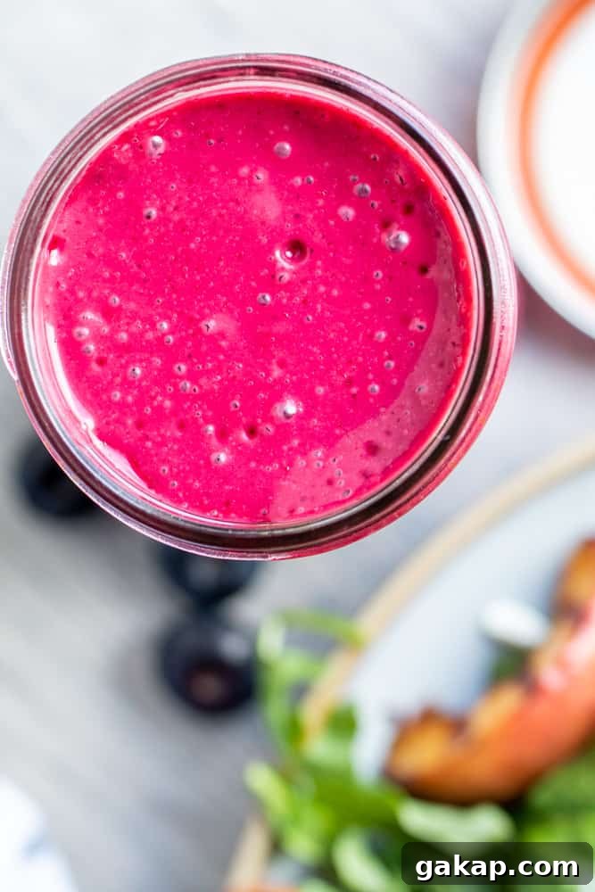 Overhead shot of dressing in a mason jar on a white counter.