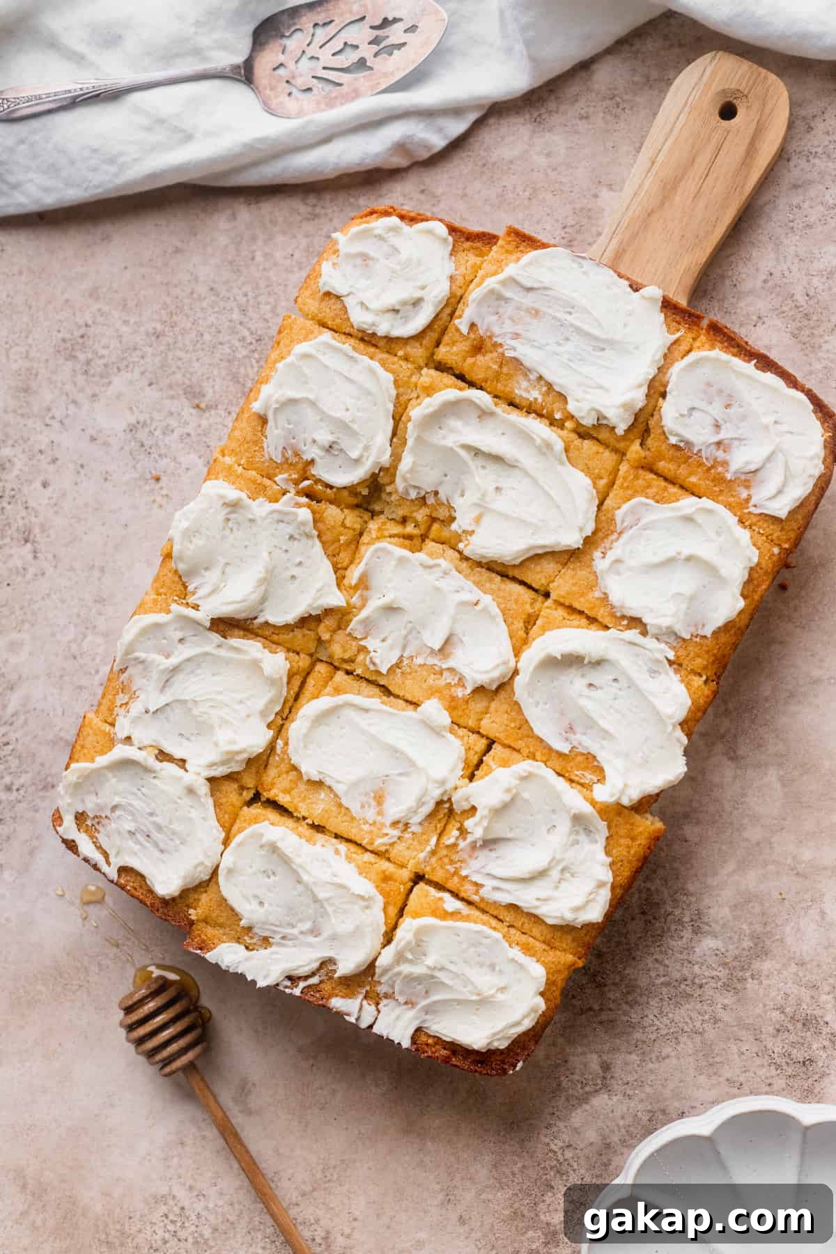 Cornbread with butter on top of cutting board.