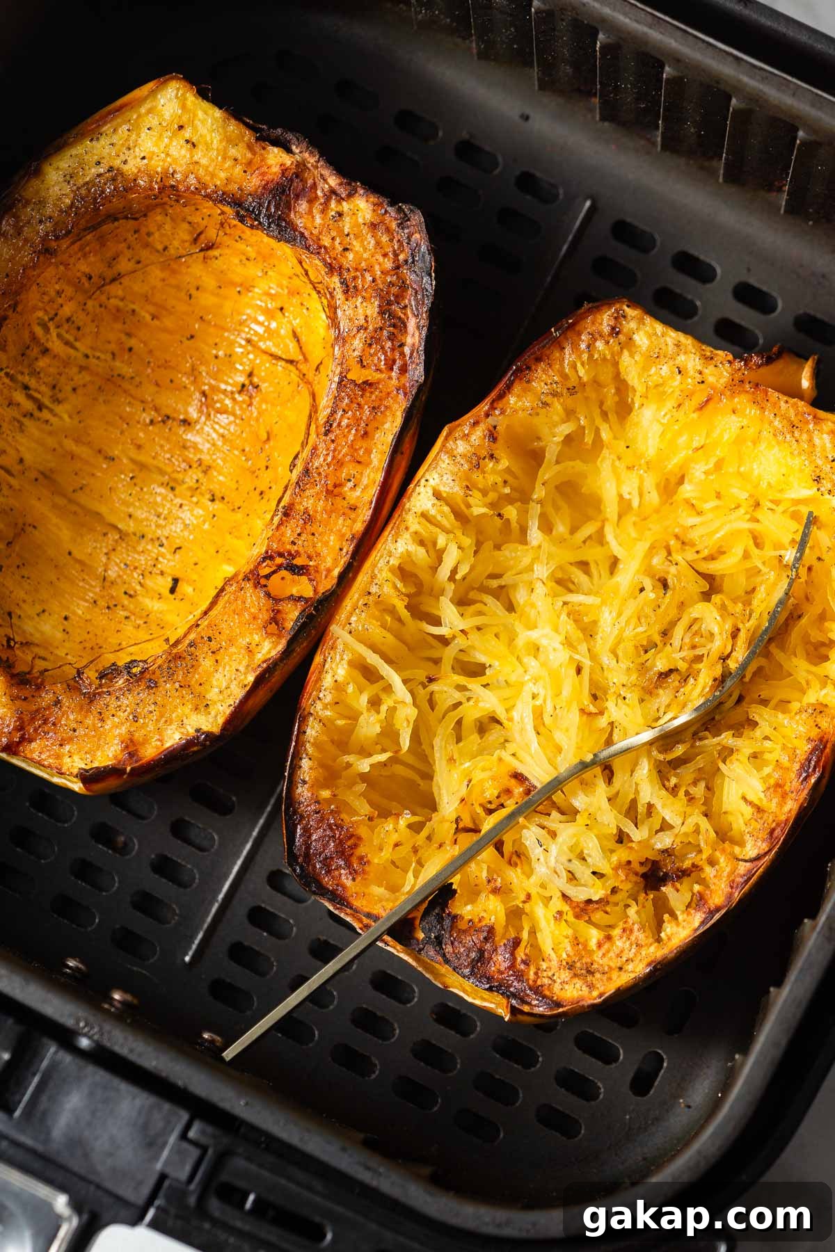 Crispy Air-Fried Spaghetti Squash Recipe for Quick Dinners 2 air fryer spaghetti squash in the air fryer basket.