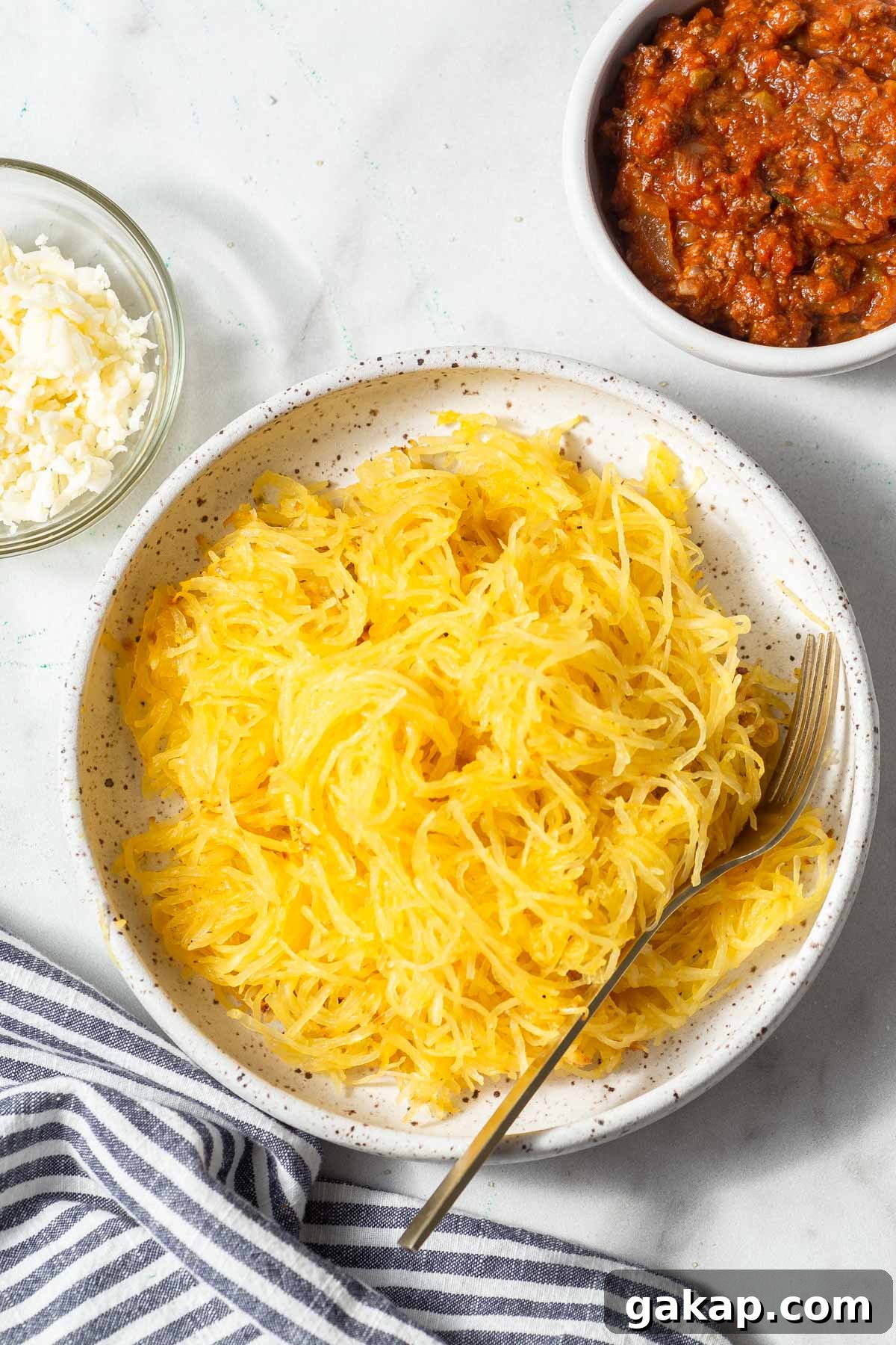 Crispy Air-Fried Spaghetti Squash Recipe for Quick Dinners 9 air fryer spaghetti squash strands on a plate.