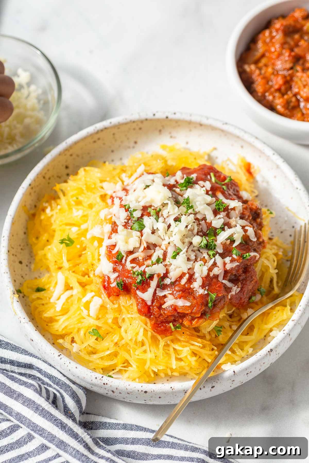 Crispy Air-Fried Spaghetti Squash Recipe for Quick Dinners 10 air fryer spaghetti squash with marinara sauce and grated cheese.