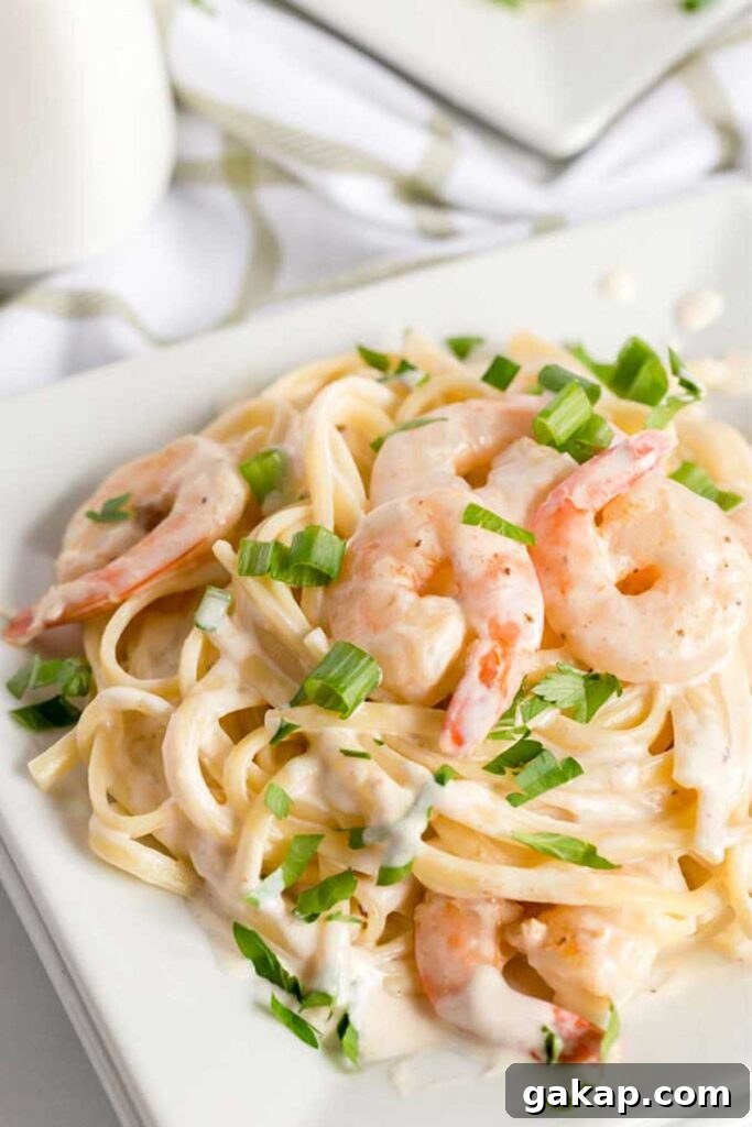 A plate with Shrimp pasta in Alfredo sauce