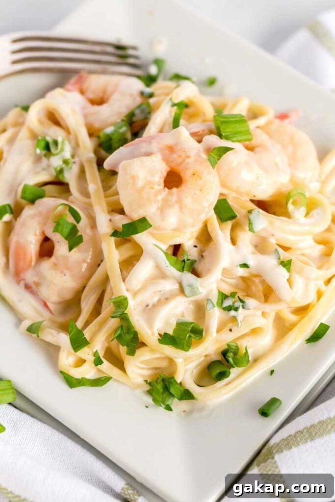Shrimp in Cajun Alfredo sauce with spaghetti in a white plate