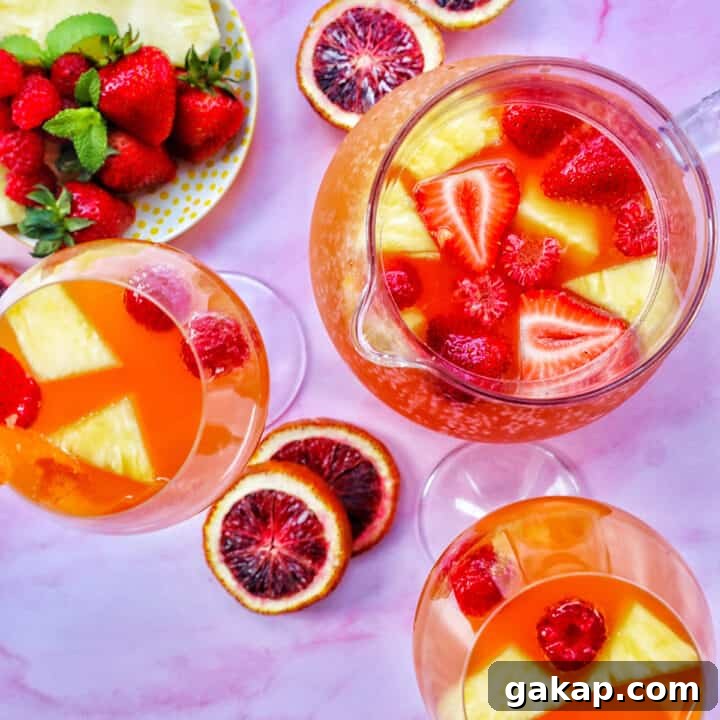 tropical rosé sangria in three glasses with blood orange slices.