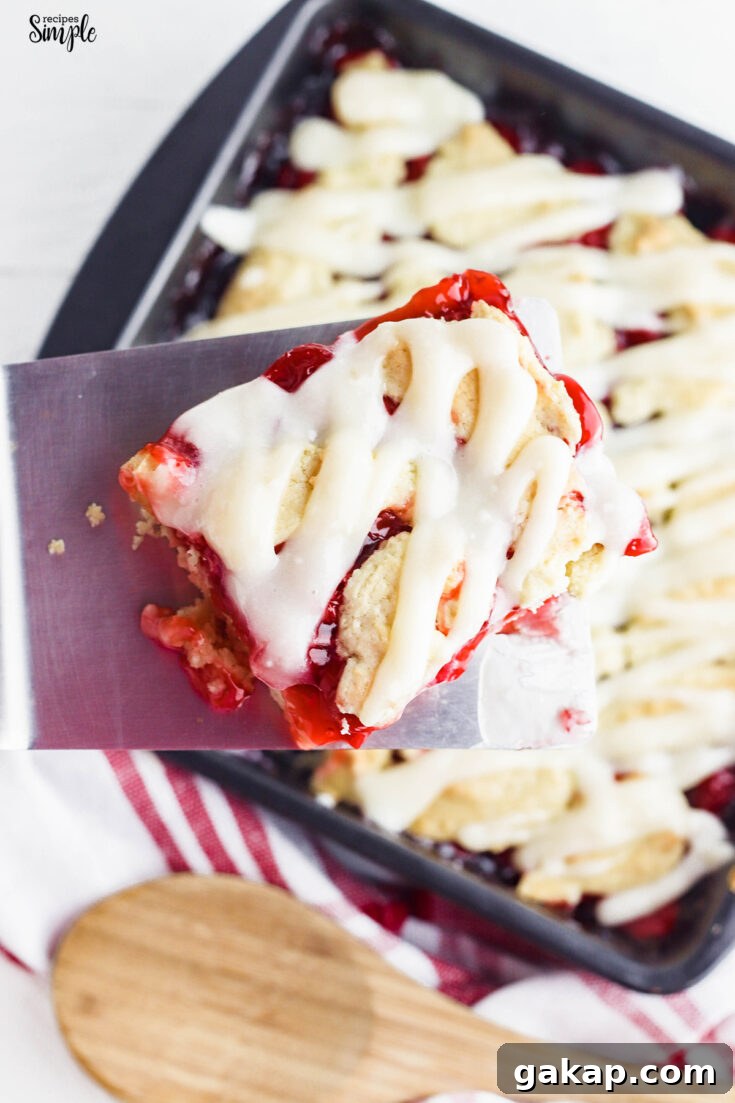 Closeup of Slice of Cherry Pie Bar over baking pan