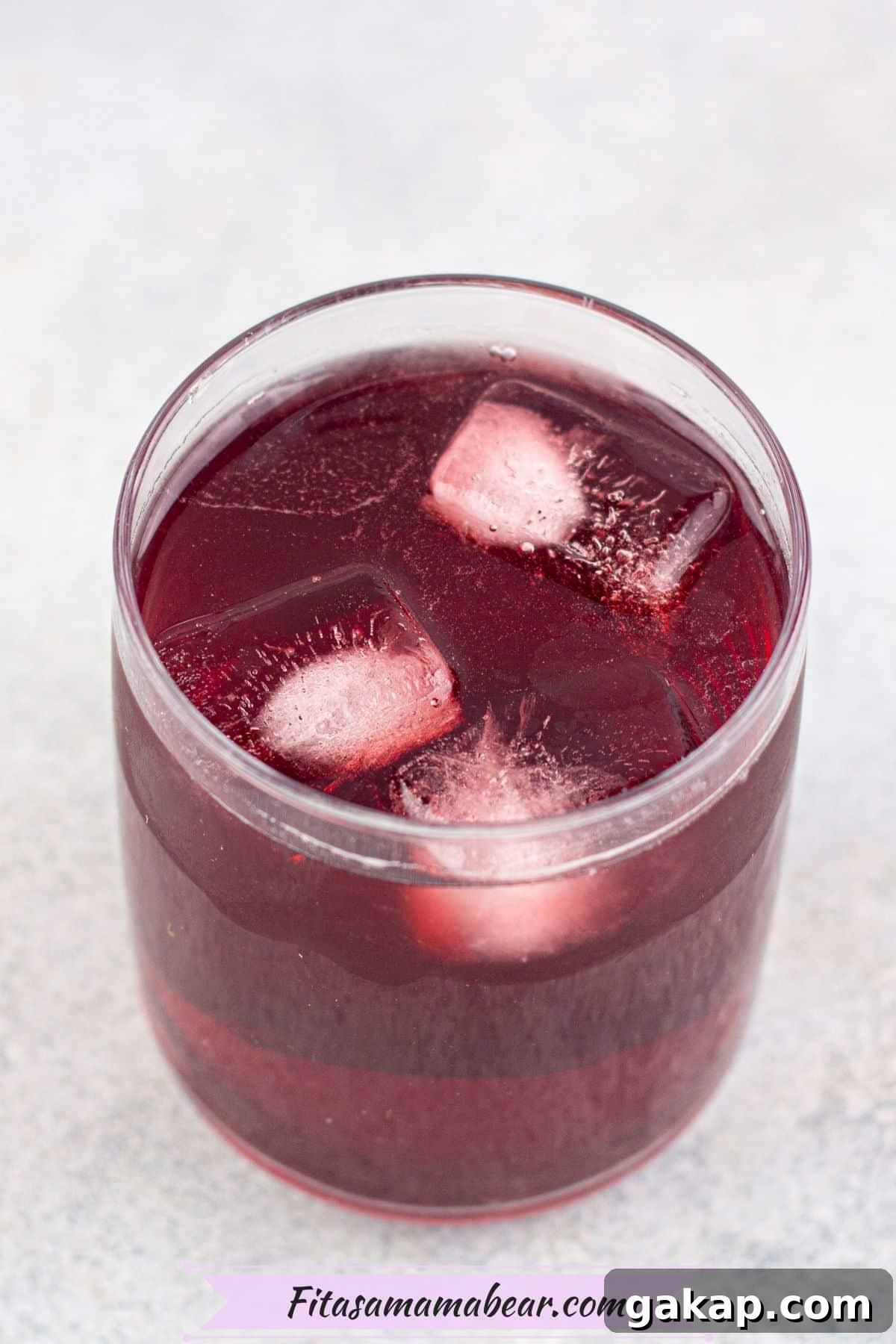 Sparkling Kombucha Mocktail Recipe for Refreshing Summer Sips 5 Red kombucha in a glass with ice cubes.