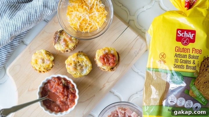 Mini Quiches on a cutting board next to a bowl of cheese and a bowl of chopped ham