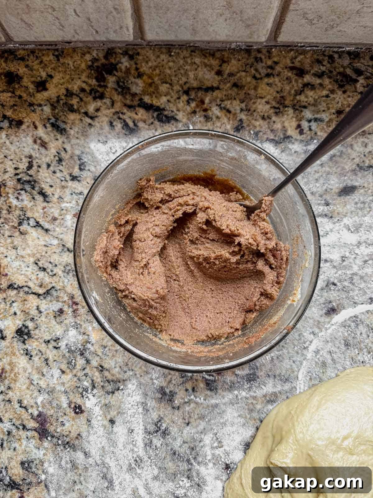 cinnamon roll filling mixed in a small bowl with a spoon.