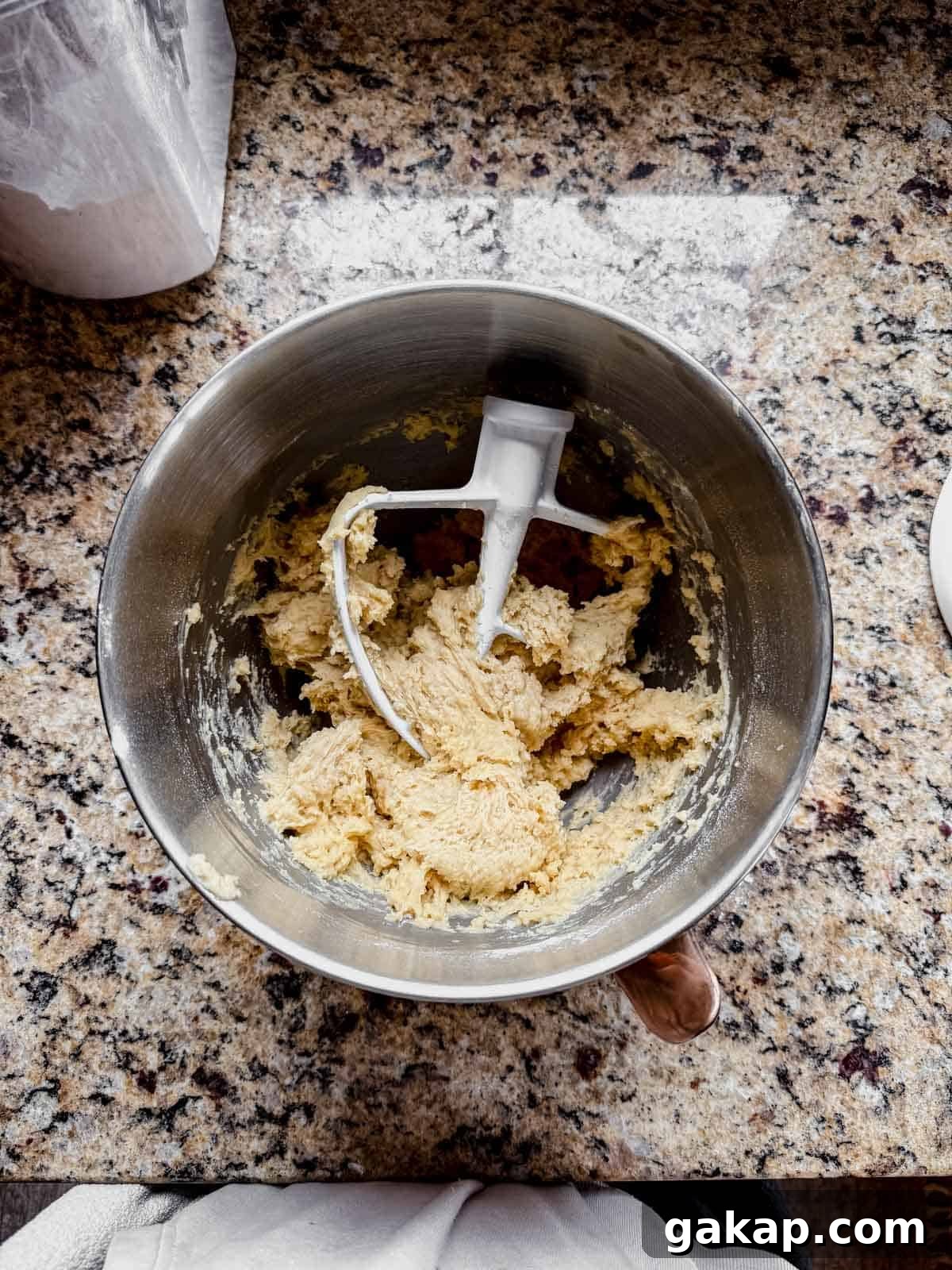 cinnamon roll dough resting in a mixing bowl.