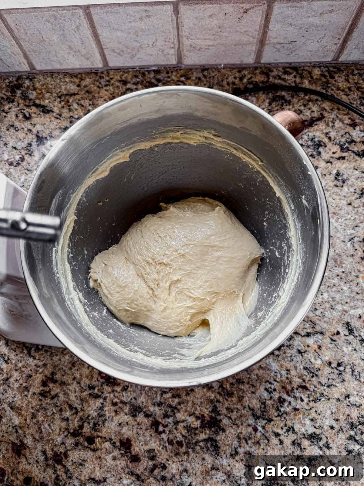 cinnamon roll dough ball after adding butter and kneading.