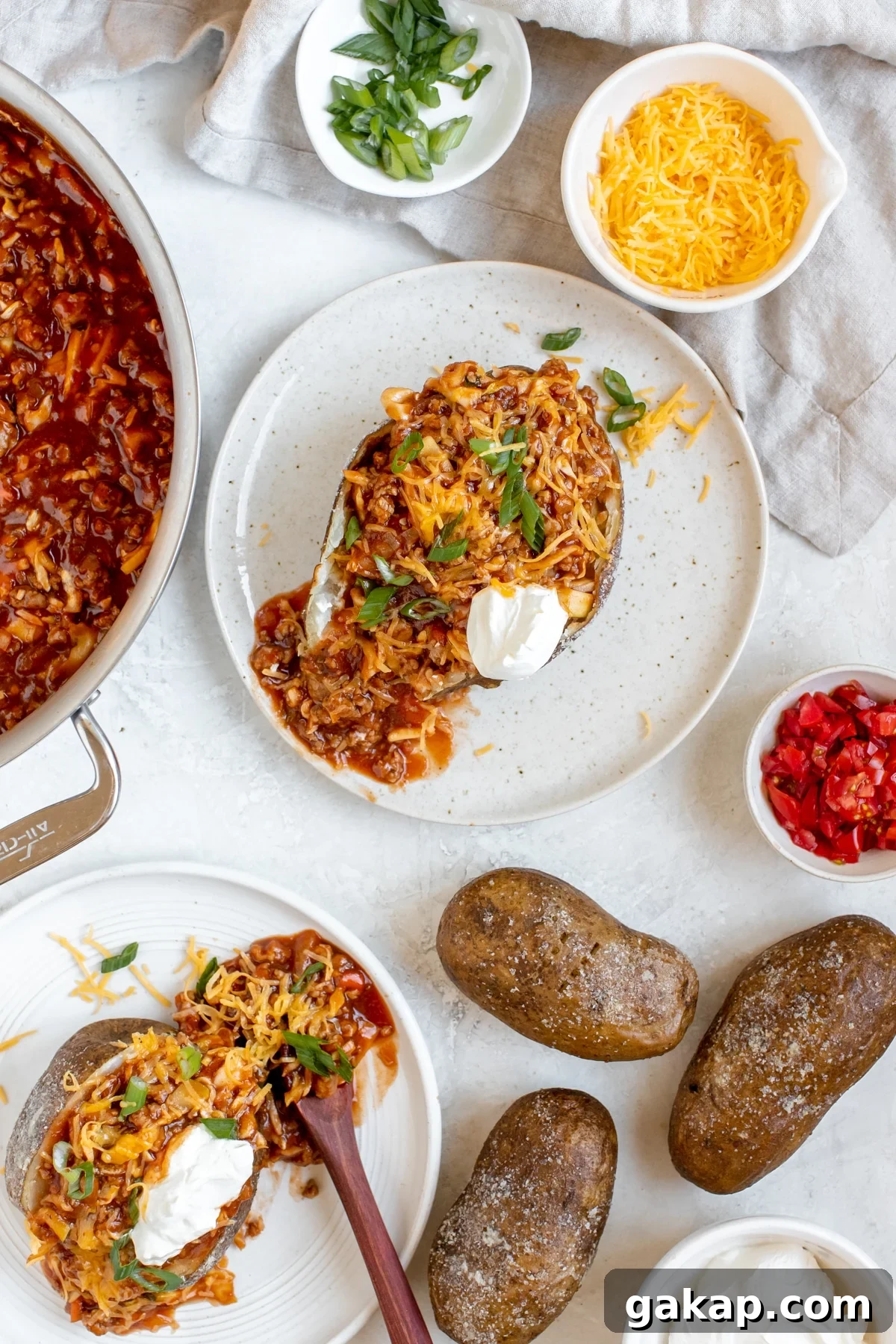 Sloppy Joe Stuffed Baked Potato Recipe: Hearty Weeknight Meal 2 a baked potato stuffed with a ground turkey meat sauce and topped with cheese, green onions and sour cream