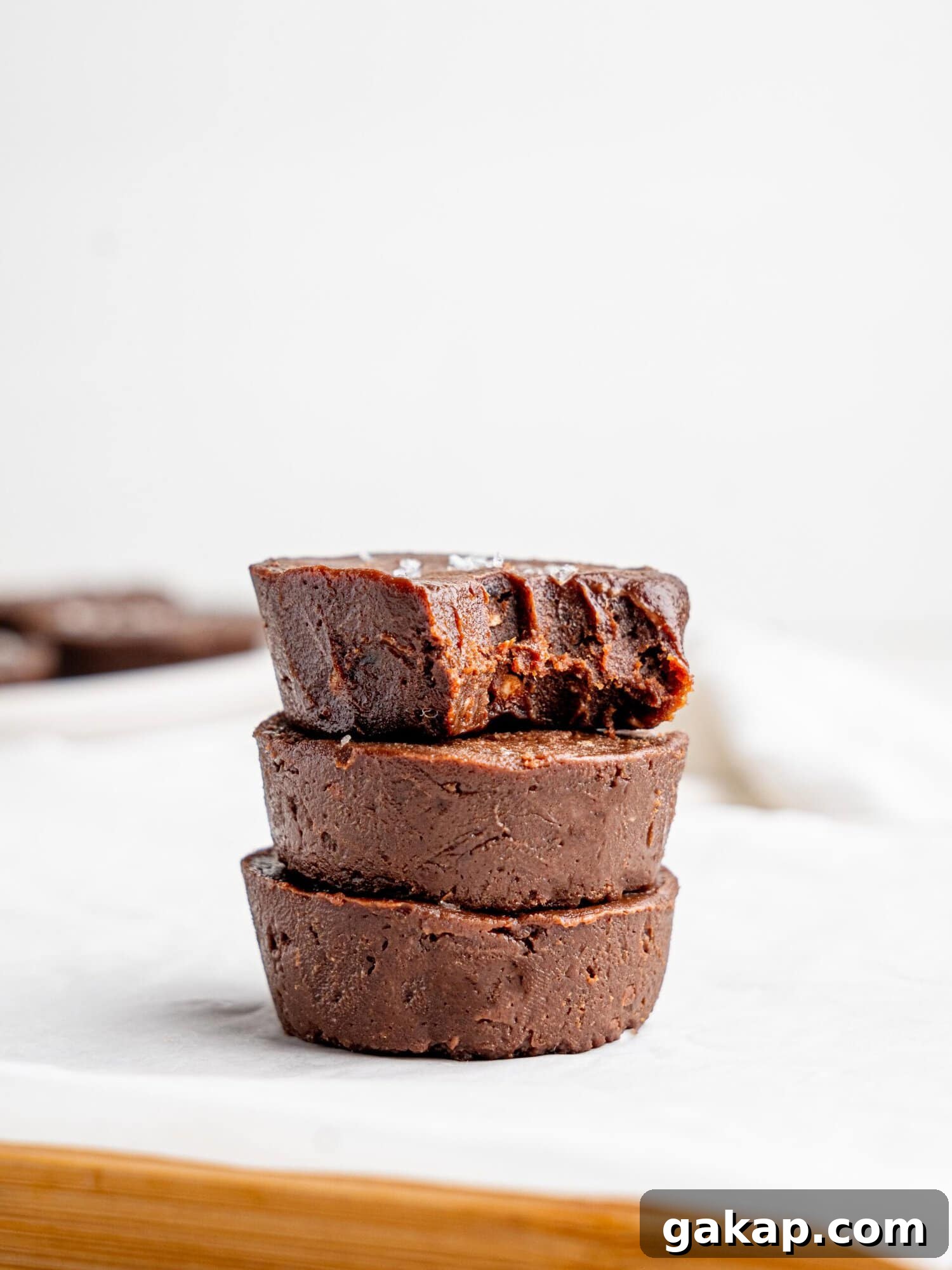 Three chocolate fudge cups stacked on top of each other.