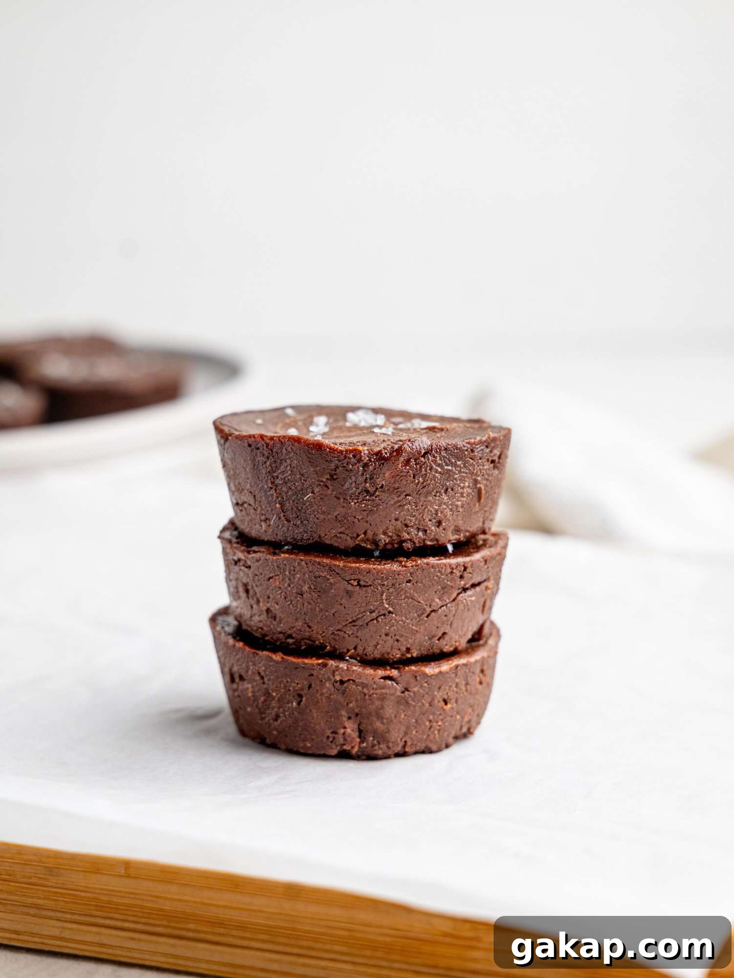 Three chocolate fudge cups stacked on top of each other.