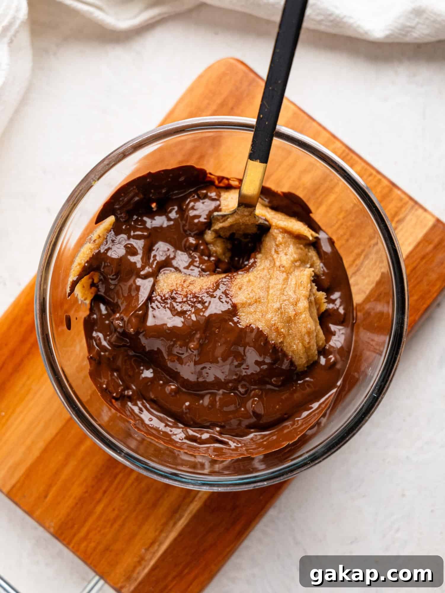 Ingredients to make chocolate fudge in a glass mixing bowl.