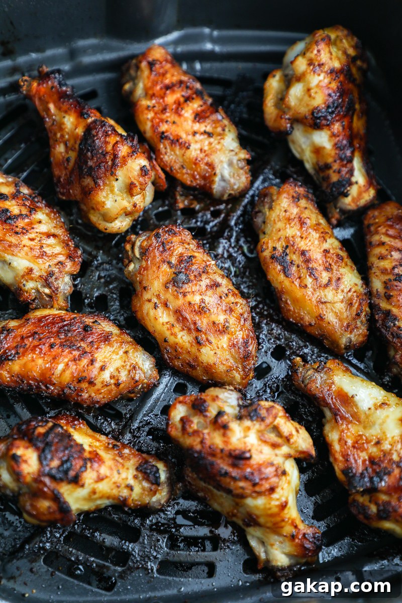 Crispy Lemon Garlic Chicken Wings Recipe 6 A close up photo of crispy marinated lemon garlic chicken wings in an air fry basket
