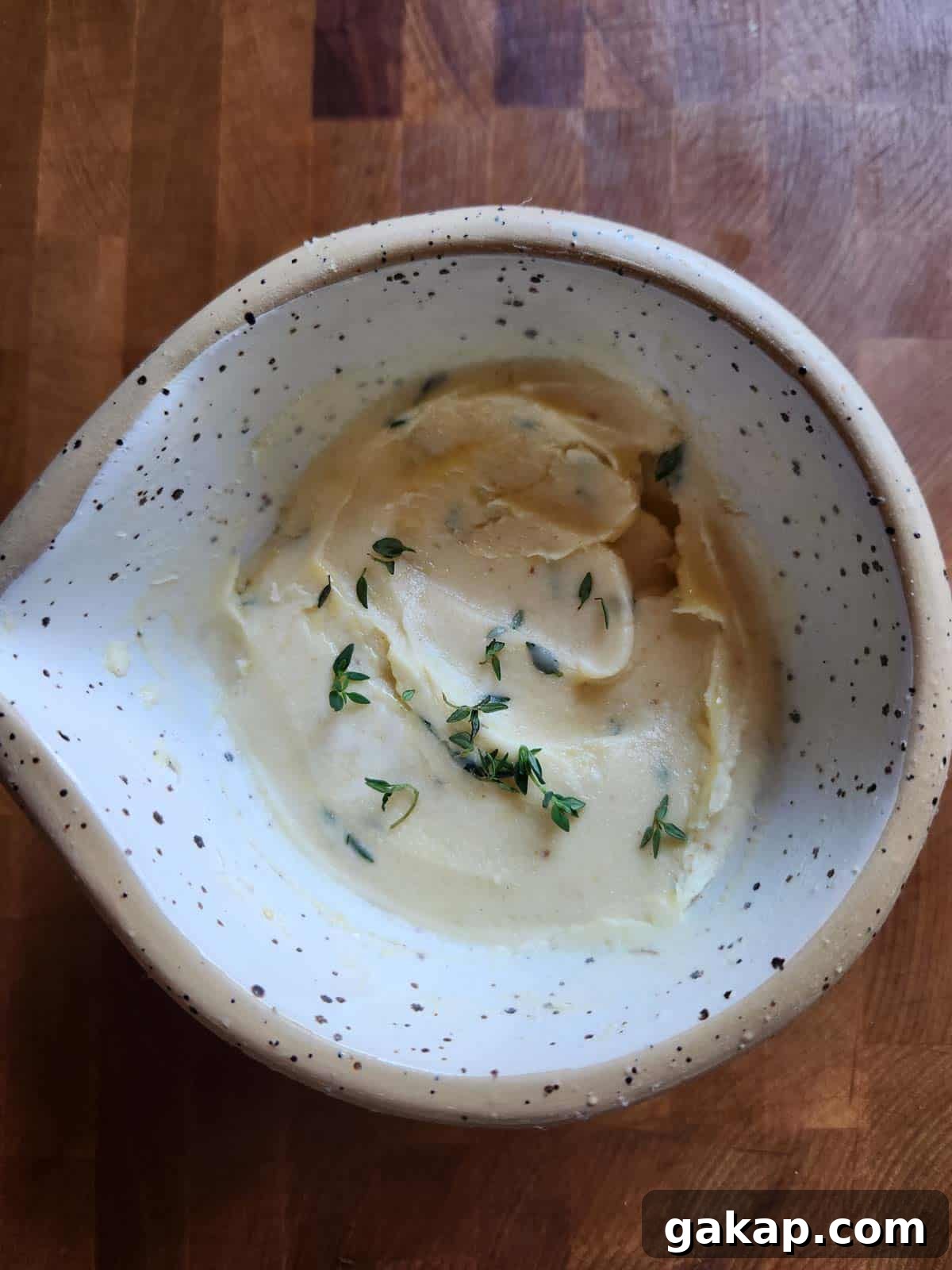Blended flavored butter in a beige bowl.