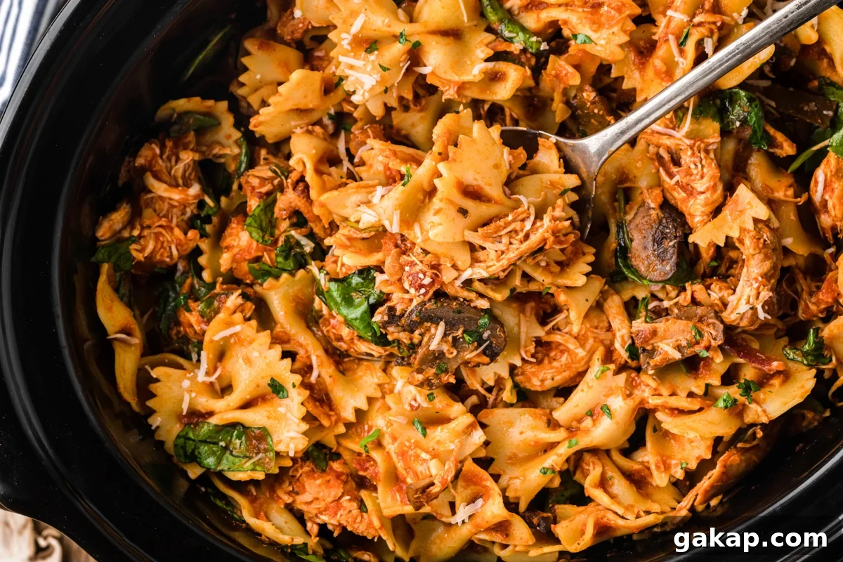 Creamy Slow Cooker Chicken and Bacon Pasta Recipe 6 overhead shot of chicken bacon pasta in a slow cooker.