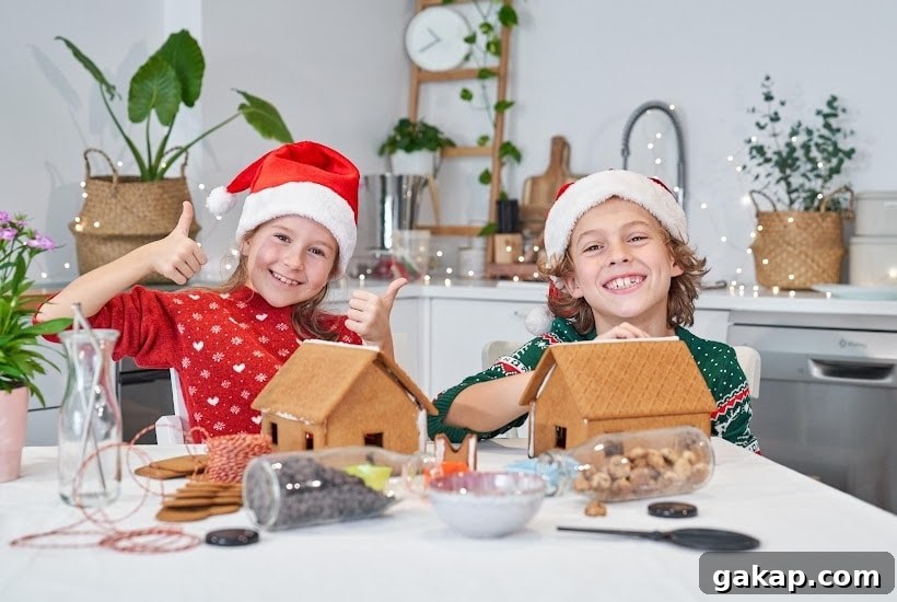 a boy and girl making gingerbread houses.